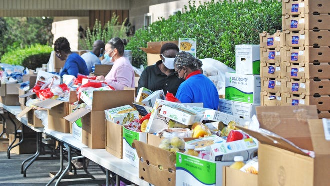 Volunteers prepare boxes of food on Nov. 21 in Williston.