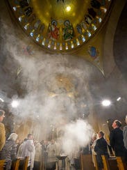 Incense rises to bless the Trinity Dome during the