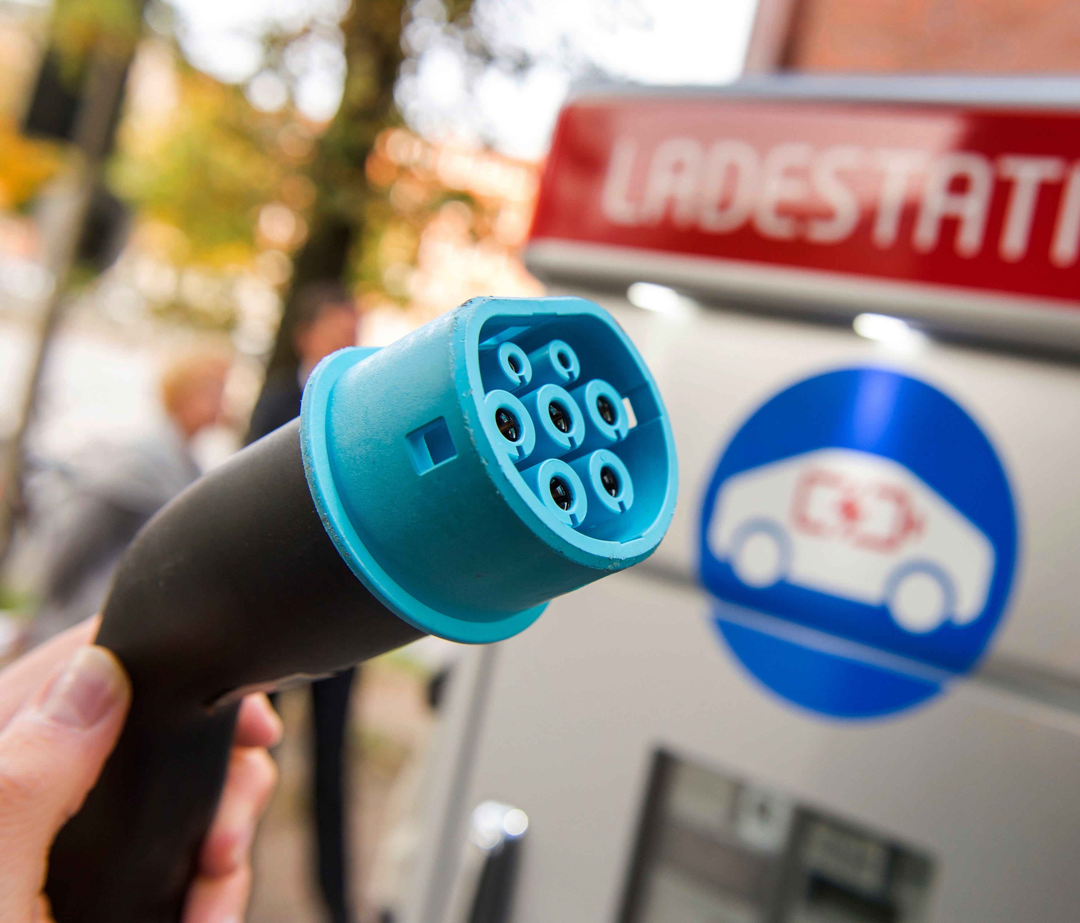 A plug is shown at a charging station for electric vehicles in Hamburg, Germany. Major automakers say their joint European electric car recharging network will open its first stations this year in Germany, Austria and Norway in what the companies hop