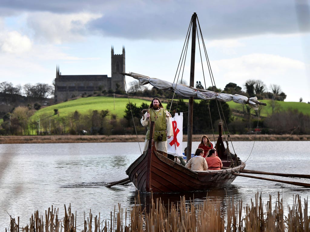 St. Patrick, played by Marty Burns, sails past Down Cathedral as the re-enactment of the first landing of St. Patrick on Irish shores takes place at Inch Abbe in Downpatrick, Northern Ireland. The Irish annals for the fifth century date Pat