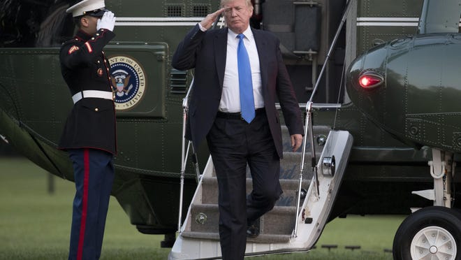 President Donald Trump salutes as he steps from Marine One on the South Lawn of the White House in Washington, Sunday, June 11, 2017, as he returns from Bedminster, New Jersey. (AP Photo/Carolyn Kaster)