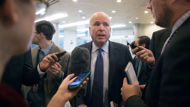 Sen. John McCain, R-Ariz., speaks to reporters about the release of a report on CIA interrogations on Dec. 9, 2014.