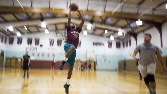 Keith McGee goes for a dunk during practice at Greece Arcadia High School on Wednesday, January 6, 2016.