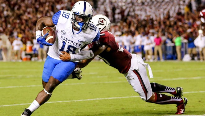 Sep 12, 2015; Columbia, SC, USA; Kentucky Wildcats running back Stanley Williams (18) runs towards a first down stopped by South Carolina Gamecocks safety T.J. Gurley (20) during the second quarter at Williams-Brice Stadium.