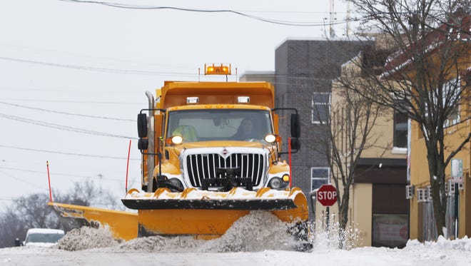 A Manitowoc Public Works plow truck removes snow off South Ninth Street on Thursday, Dec. 31.
