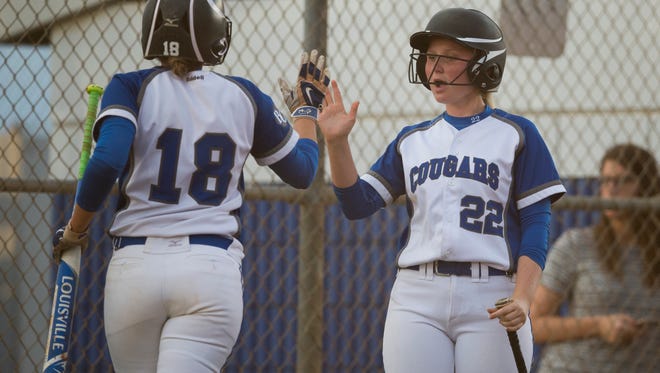 Barron Collier's Megan Scoone (22) congratulates Maddie Noble (18) after Noble scored a run against Mariner during the Class 6A regional quarterfinal at Barron Collier High School Wednesday, May 3, 2017 in Naples. Barron Collier would go on to advance with the win defeating Mariner 3-0. 
