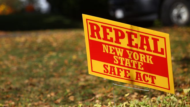 A file photo of a sign urging the repeal of the SAFE Act on a lawn in Perinton.