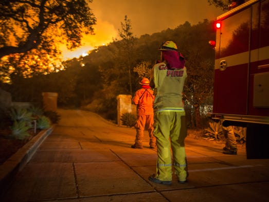 Firefighters watch flames as the Thomas Fire approaches