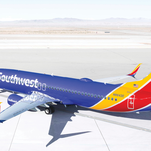 Southwest jet on taxiway in desert landscape.
