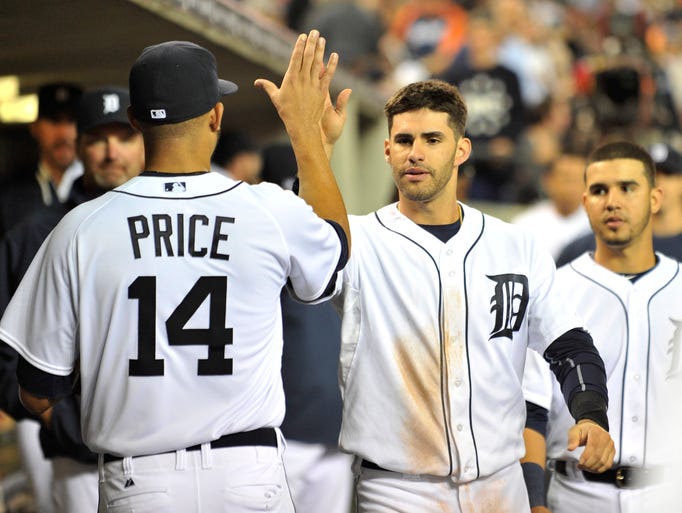 Tigers pitcher David Price high fives J.D. Martinez after Martinez caught a long fly ball off the bat of Chicago's Josh Phegley to end the top of the fifth inning.