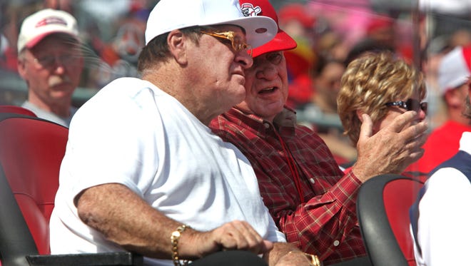 Pete Rose (left) chats with Reds CEO and principal owner Bob Castellini (right) during a game in September of 2014.