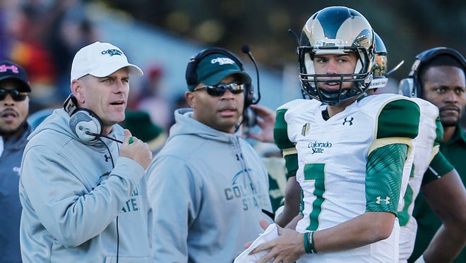 CSU coach Mike Bobo talks to quarterback Nick Stevens during a timeout in a Nov. 7 game at Wyoming. Stevens will have to beat out some good competition this spring to keep the starting job.