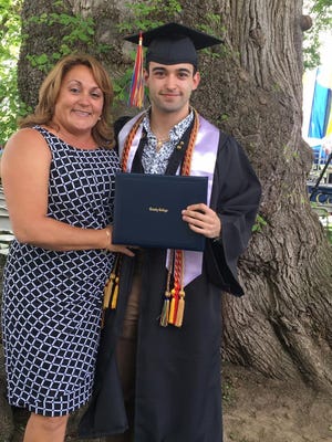 Suarez poses with his mom, Belkis Casas, after crossing the stage in May at Trinity College in Connecticut.
