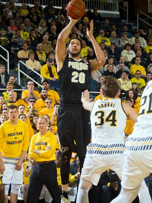 Purdue center A.J. Hammons (20) shoots over Michigan forward Mark Donnal (34) in the first half of an NCAA college basketball game in Ann Arbor, Mich., Saturday, Feb. 13, 2016. (AP Photo/Tony Ding)