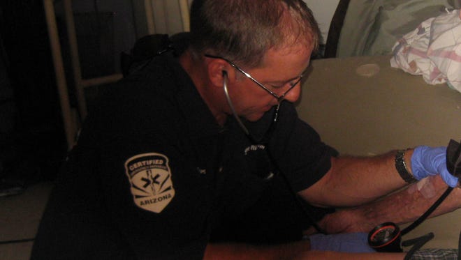 Scottsdale Paramedic Steve Richter, part of the Mobile Integrated Healthcare Practice, checks a patient's blood pressure.