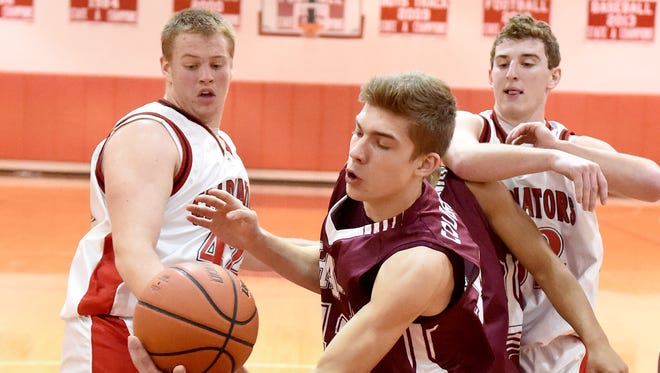 Stuarts Draft's Gage Frazier beats Riverheads' Kendall Casto and John Agnor to the ball in a battle for the rebound during a basketball game played in Greenville on Thursday, Jan. 15, 2015.