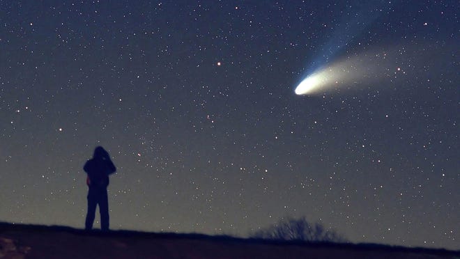 An observer watches the Hale-Bopp comet in 1997. A University of Cincinnati archaeologist has suggested an exploding comet roughly 1,700 years ago brought an end to the Hopewell culture in southern Ohio.