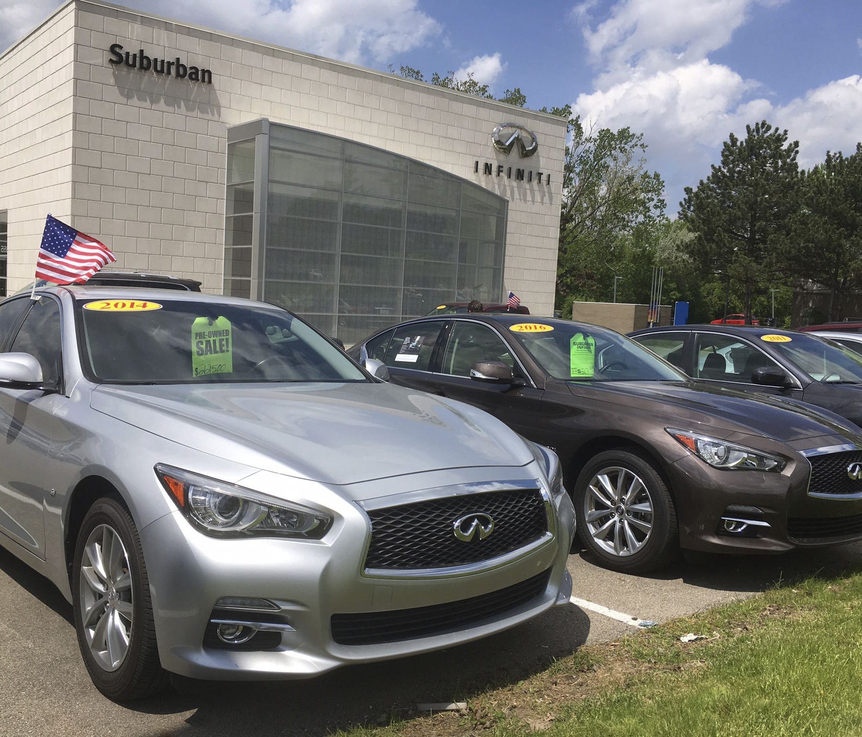 Used Infiniti Q50 luxury sedans await buyers at a dealership in the Detroit suburb of Novi, Mich. Leases are ending on a large number of Q50s and other cars, flooding the market with quality used cars.