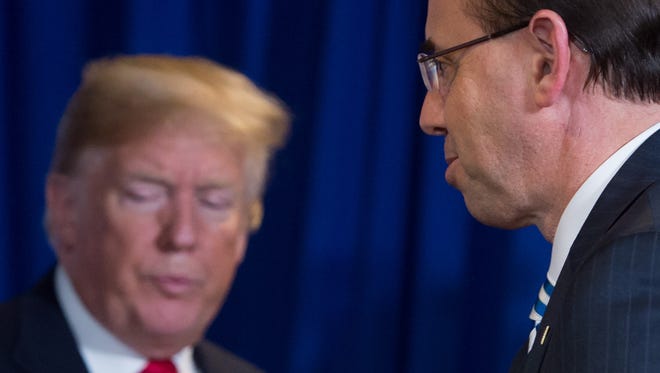 US President Donald Trump stands alongside Rod Rosenstein (R), US Deputy Attorney General, during a roundtable discussion on immigration at Morrelly Homeland Security Center in Bethpage, New York, May 23, 2018. / AFP PHOTO / SAUL LOEBSAUL LOEB/AFP/Getty Images ORIG FILE ID: AFP_15A2V6