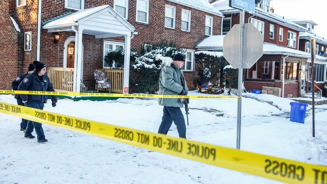 Police investigate the scene after Deputy U.S. Marshal Christopher David Hill was killed when a gunman opened fire on law enforcement officers serving an arrest warrant inside a home earlier in the area, Thursday, Jan. 18, 2018, in Harrisburg, Pa. (Dan Gleiter/PennLive.com via AP)