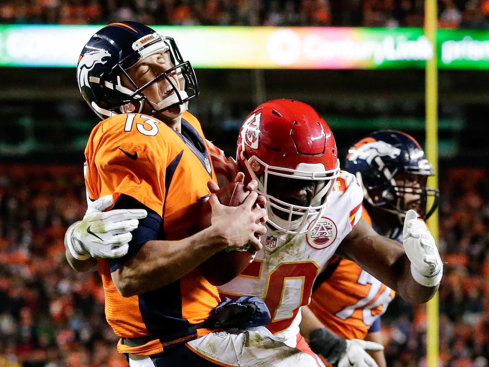 Denver Broncos quarterback Trevor Siemian (13) is sacked by Kansas City Chiefs outside linebacker Justin Houston (50) in the second quarter at Sports Authority Field at Mile High.