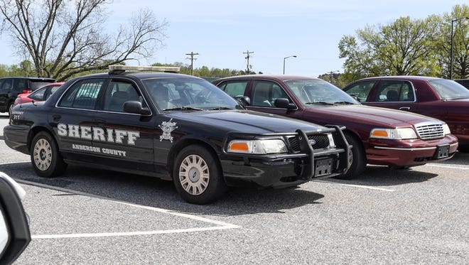 Anderson County Sheriff's Office uses a variety of work vehicles. Black, white, burgundy, and grey.