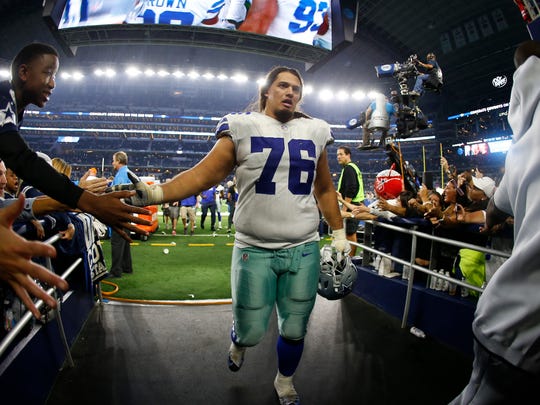 Dallas Cowboys offensive guard Xavier Su'a-Filo (76) greets fans as he comes off the field following an NFL football game against the Washington Redskins in Arlington, Texas, Thursday, Nov. 22, 2018. The Cowboys defeated the Redskins 31-23. (AP Photo/Ron Jenkins)
