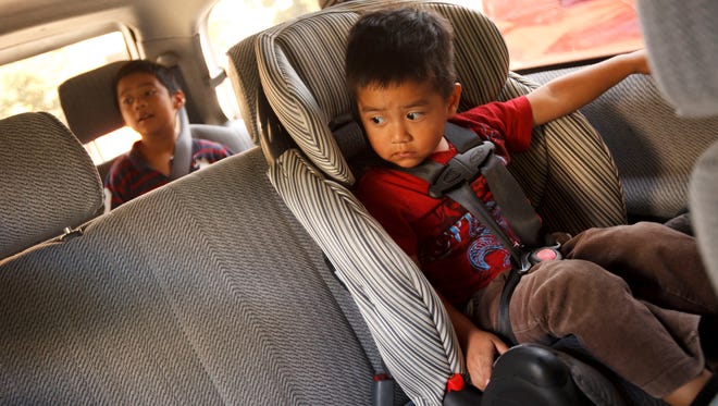 Frank Lopez, front, and Eddie Lopez, rear, are buckled in their new seats during a free chid safety seat check at Children's Hospital of Los Angeles on Sept. 18, 2012, in Los Angeles.