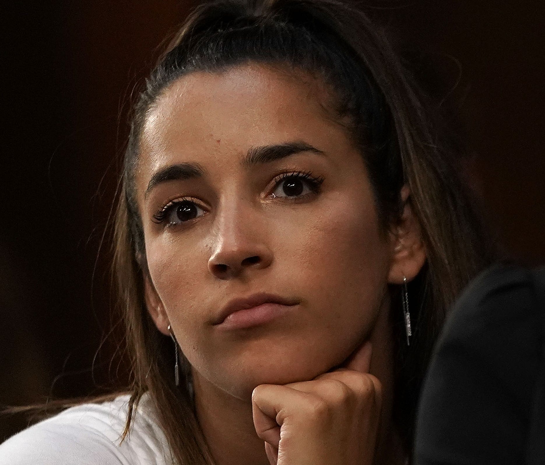 Aly Raisman listens during a Senate hearing to focus on changes made by the U.S. Olympic Committee, USA Gymnastics and Michigan State University to protect Olympic and amateur athletes from abuse.