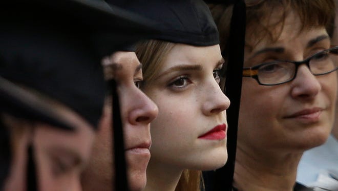 Emma Watson, center right, attends commencement services on the campus of Brown University, Sunday, May 25, 2014, in Providence, R.I.