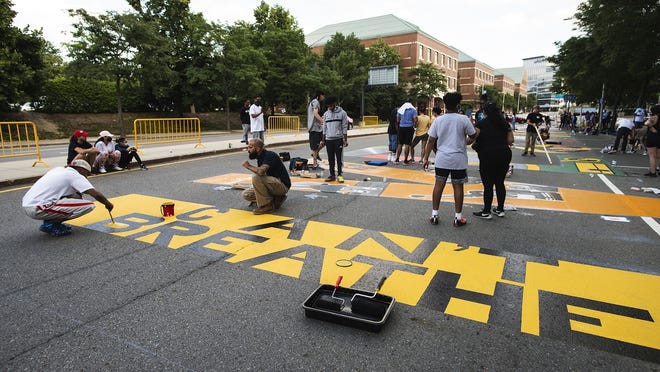 Artists and volunteers, who started painting at 6 a.m., continued into the evening July 15 to finish a Black Lives Matter mural at the intersection of Major Taylor Blvd. and MLK Jr. Blvd.