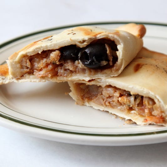 La Roja de Todos in Corona serves Chilean cuisine, such as this empanada de pino with beef, onions, raisins, olives, and hard-boiled egg. This is one of Culinary Backstreets' picks for dining near the U.S. Open in Queens.