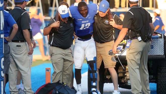 MTSU's Demetrius Frazier (13) gets placed on a gator after Frazier injuried himself while scoring a touchdown, during a home game against Alabama A&M's, on Saturday, Sept. 3, 2016.