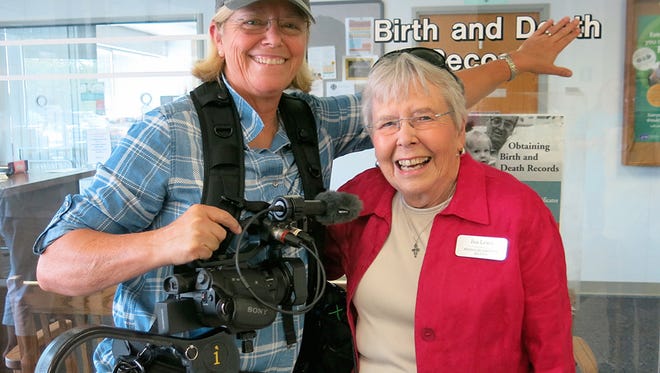 In this August 2016 photo provided by Jean A. S. Strauss, the filmmaker, left, stands with one of her subjects, Ina Lewis, in Jefferson City, Mo., on the first day senior citizen adoptees in the state got their original birth certificates. Strauss, a California-born adoptee, has lobbied in her home state for a bill to expand adoptees' access to their birth certificates. (Heather Dodds/Jean A. S. Strauss via AP)
