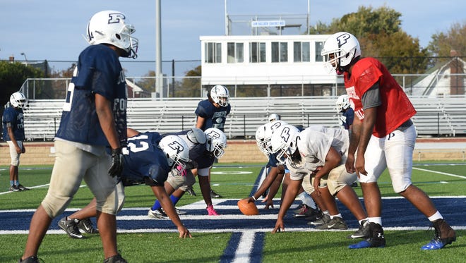Poughkeepsie High School's football team lines up to run plays during practice last fall.