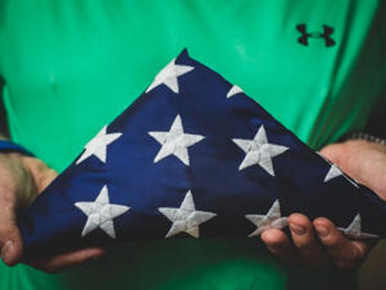 Retired Staff Sgt. Rodney Dean Kerksieck holds a folded