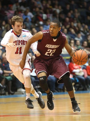 Aquinas junior guard Jalen Pickett (22) is guarded by Fairport's Nick Lapp in the Section V Class A final.