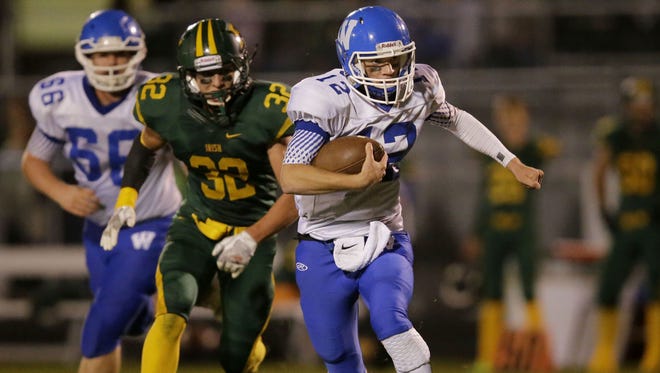 Quarterback James Hansen of Wrightstown is pursued by Brody Brozewski of Freedom in a North Eastern Conference football game on Sept. 29.