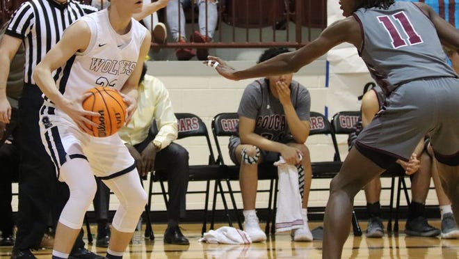 Shawnee’s Tanner Morris (22) is guarded by Ada’s Kaden Cooper (11) Saturday night in the championship game of the East Central Oklahoma Classic at Ada High School.
PHOTO BY BRIAN JOHNSON