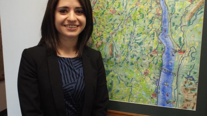 Julia Pagones, community investment program specialist for the Dutchess County Department of Planning and Development, stands alongside a county map outside her office.