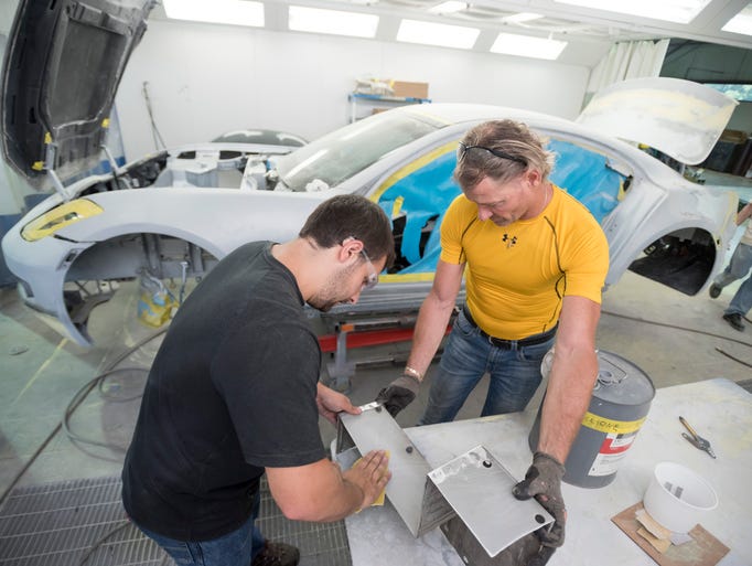 Technicians Joe Metz, left, and Bill Wetherholt work