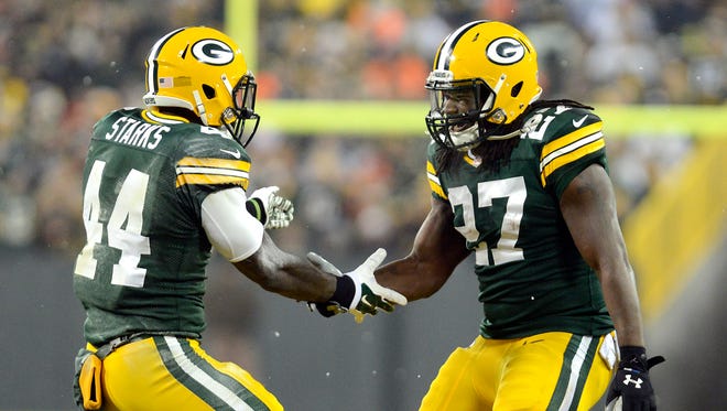 Green Bay Packers running backs James Starks (44) and Eddie Lacy (27) celebrate Lacy's first quarter touchdown against the Atlanta Falcons at Lambeau Field.