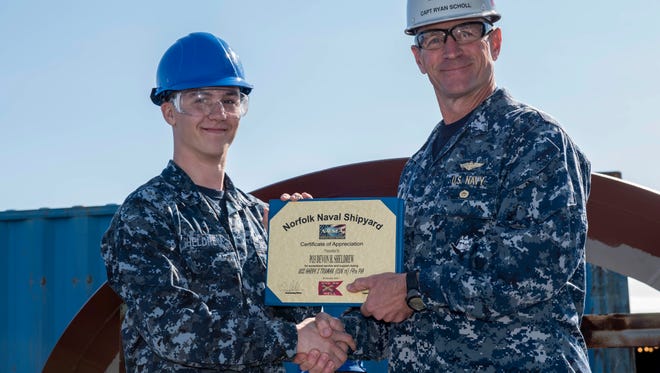 Petty Officer 3rd Class Devon Sheldrew receives recognition as a sailor of the week on the flight deck of aircraft carrier USS Harry S. Truman (CVN 75).