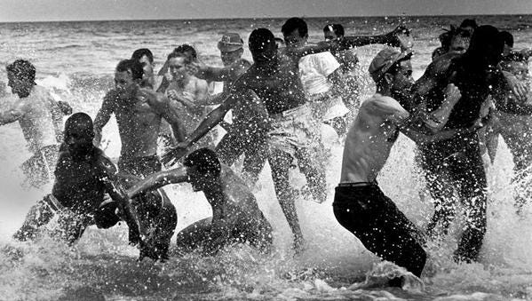 Mob attacks protesters wading into water at "whites-only" Biloxi Beach on April 24, 1960.