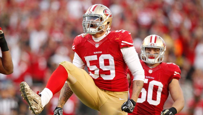 San Francisco 49ers linebacker Aaron Lynch (59) reacts after a defensive stop against the Washington Redskins.