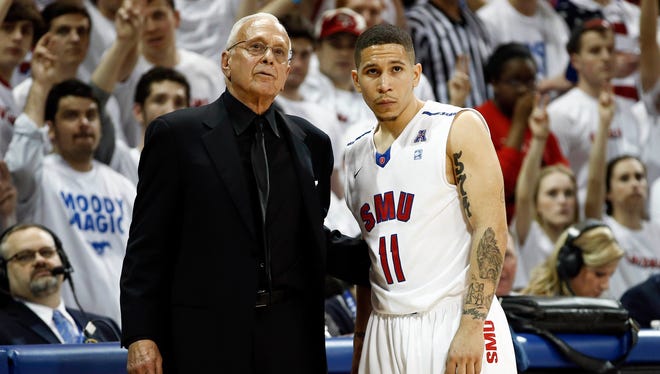 Southern Methodist coach Larry Brown and guard Nic Moore (11) look on from the sidelines during the second half against the against the Louisville Cardinals at Moody Coliseum.
