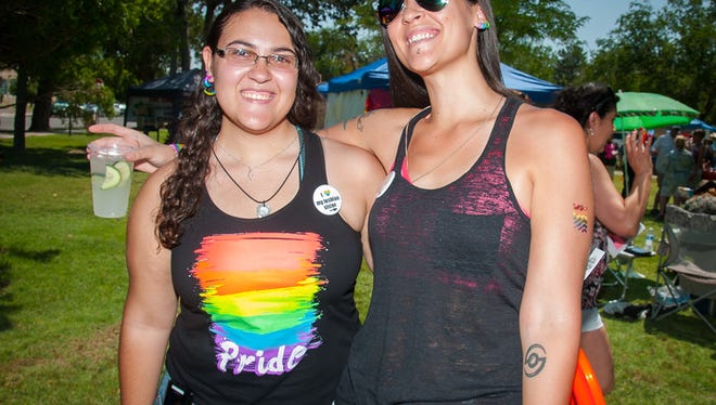 Logan Nazario, left, wears a "I love my lesbian sister" button while standing next to her sister, Ariana Nazario, at the 'Pride in the Park' festival at Pioneer Women's Park in Las Cruces in June 2015.
