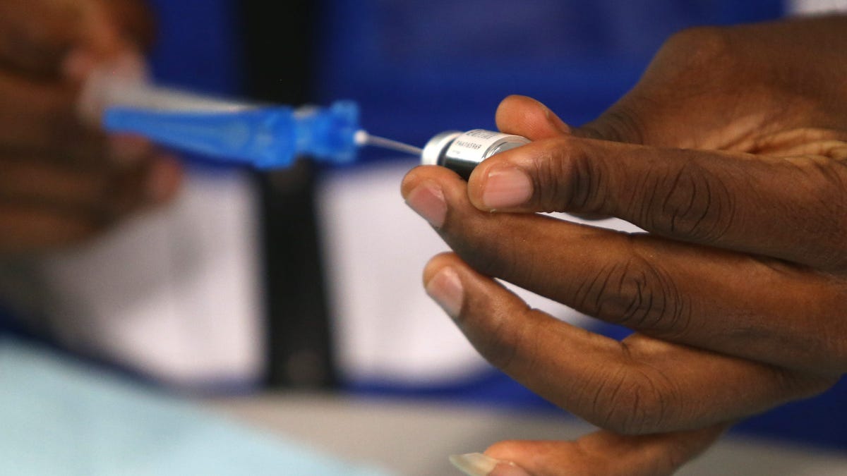 Abe Oluwasegun, an advanced practice registered nurse, readies a vaccine during a clinic in the West End of Louisville, Kentucky, at the Shawnee Arts & Cultural Center on Oct. 14.