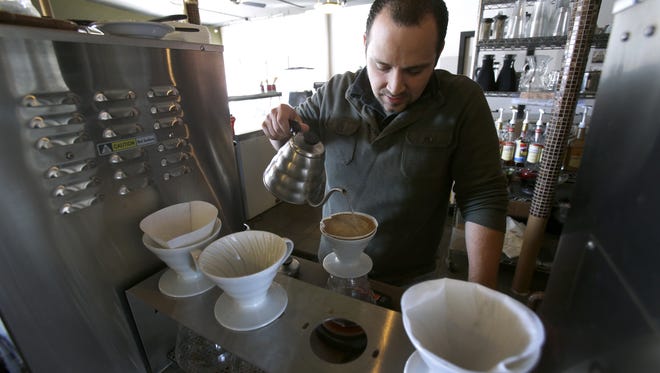 Owner Seth Lenz uses freshly ground beans to make an individual cup of coffee at Seth's Coffee & Bake Shop 
in downtown Little Chute.  In the future Appleton drive-thru location, he says they'll speed things up in the interest of time.