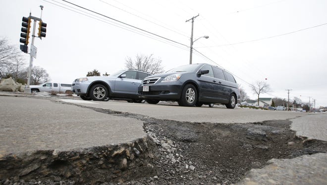 A large pothole is seen Tuesday near the corner of South Oneida and West Seymour streets in Appleton.